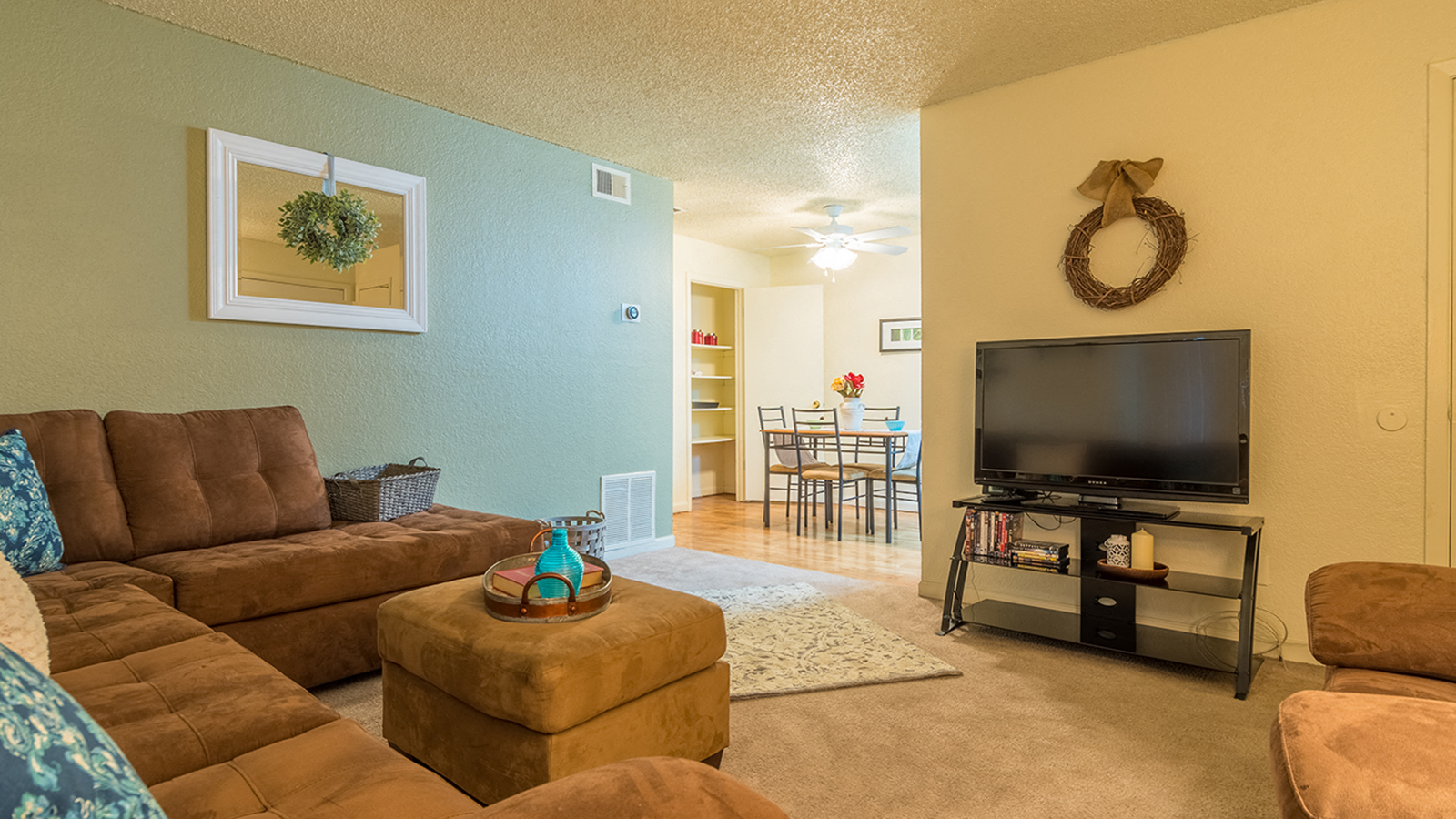 Somerpointe living room with plenty of couches and lounging space with carpet flooring